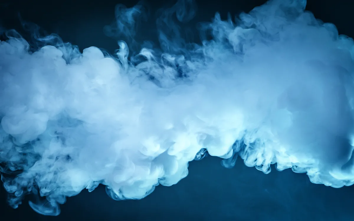 image full of billowing cloud of smoke on a dark blue background