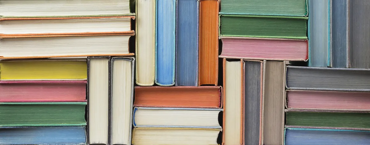 blue, pink, yellow, green, orange and white books stacked across an image