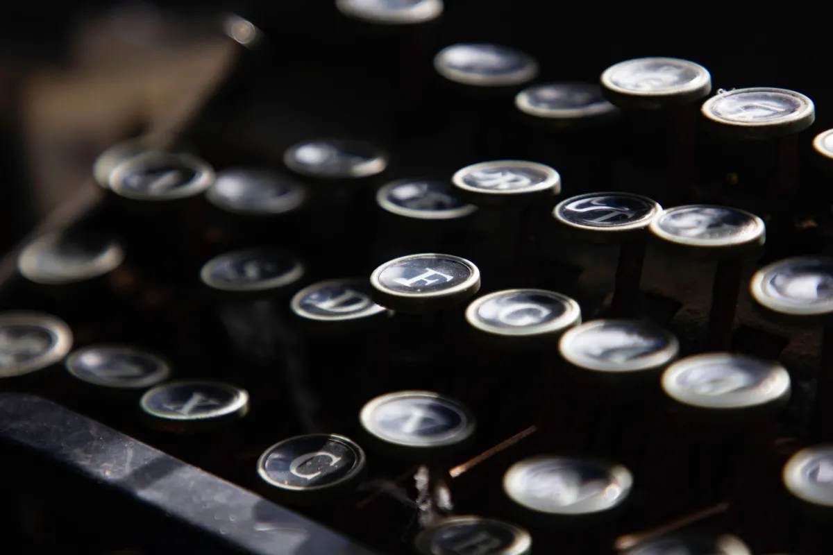 close-up image of black typewriter keys at varying angles