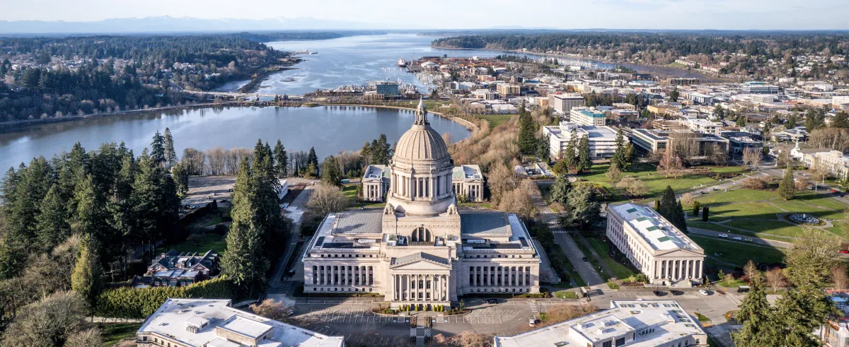 aerial view image of the capitol campus of Washington in Olympia, with the puget sound in the background on a clear day