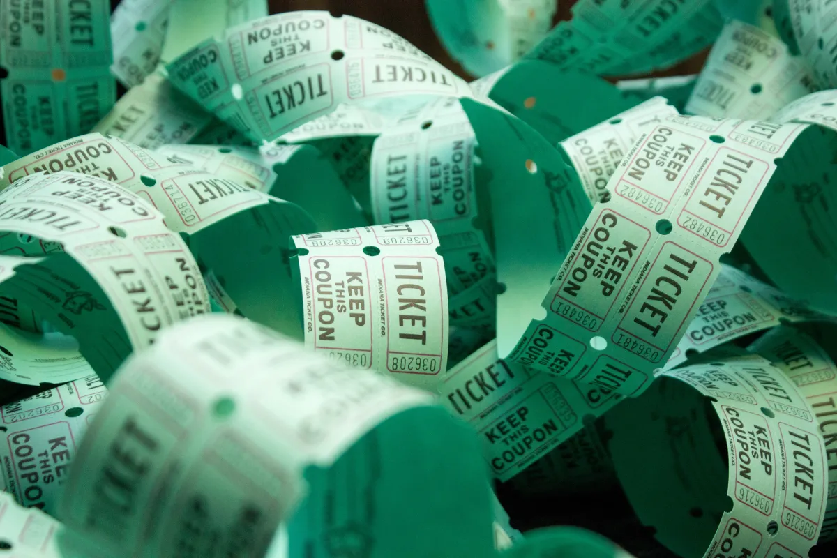 an unrolled line of light green raffle tickets