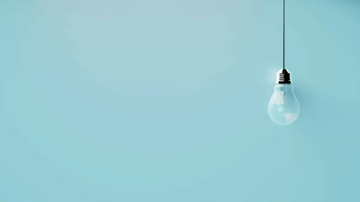 a single lightbulb on a light blue background