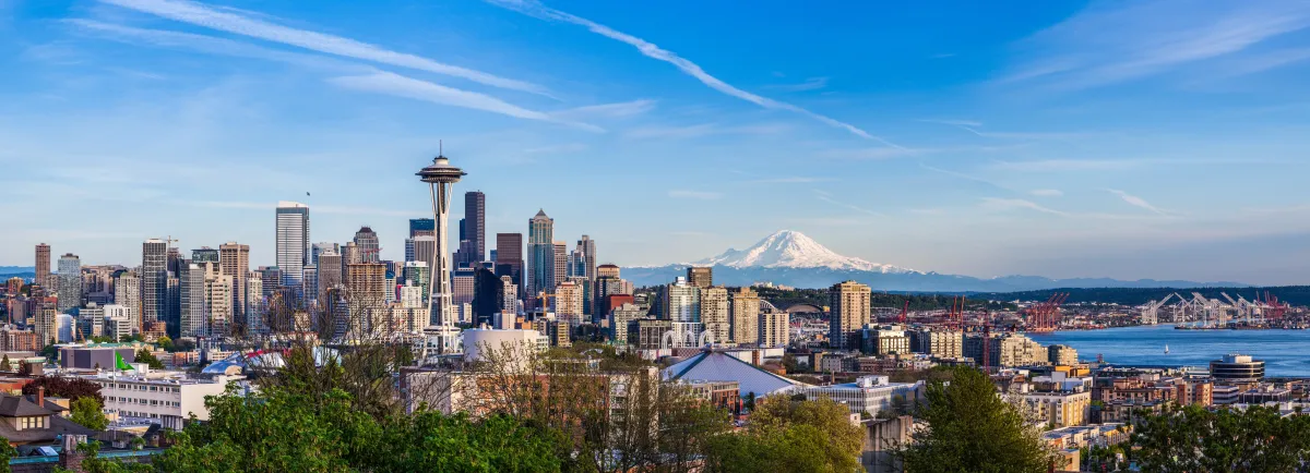 image of the Seattle skyline on a blue sky with Mt. Rainier in the background